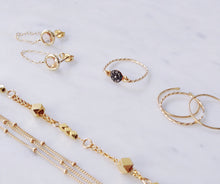 Gold fine jewellery collection by Australian jewellery brand - rough diamond ring, thin gold rings, dainty earrings and fine chain bracelets