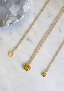 Delicate gold necklaces personalised with initial pendants