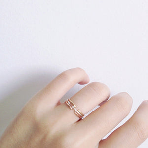 Dainty and delicate rings stacked together in gold, sterling silver and rose gold