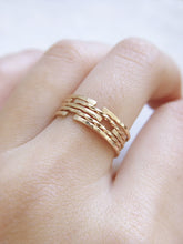 5 dainty gold ring bands with classic, hammered and twisted finishes, worn stacked